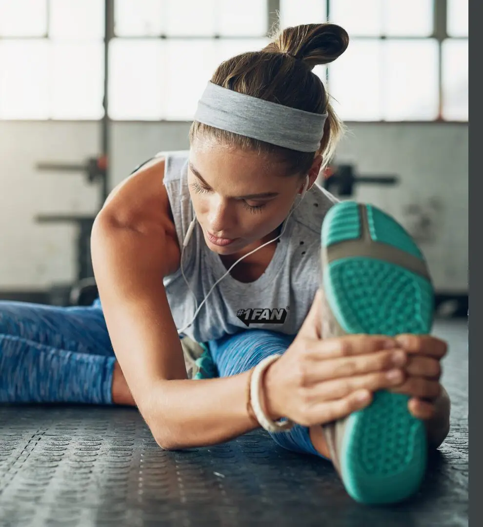 Woman stretching leg before workout indoors.
