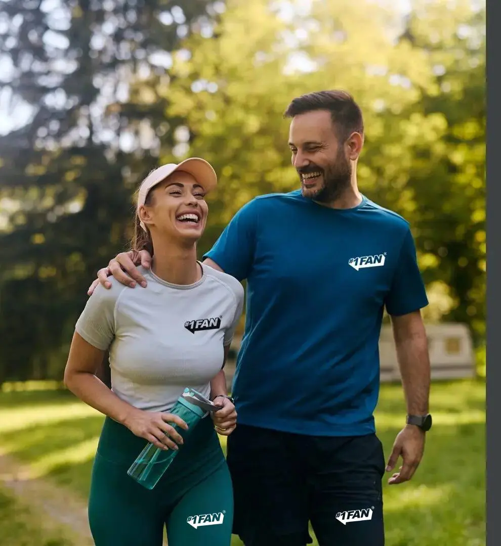 A happy couple enjoying a walk outdoors on a sunny day.