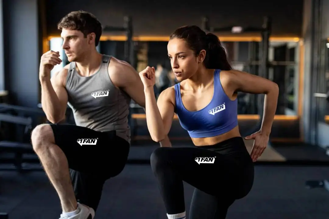 Two people running on treadmills in a gym.